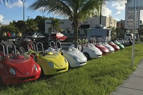 a row of parked motorcycles sitting on the grass